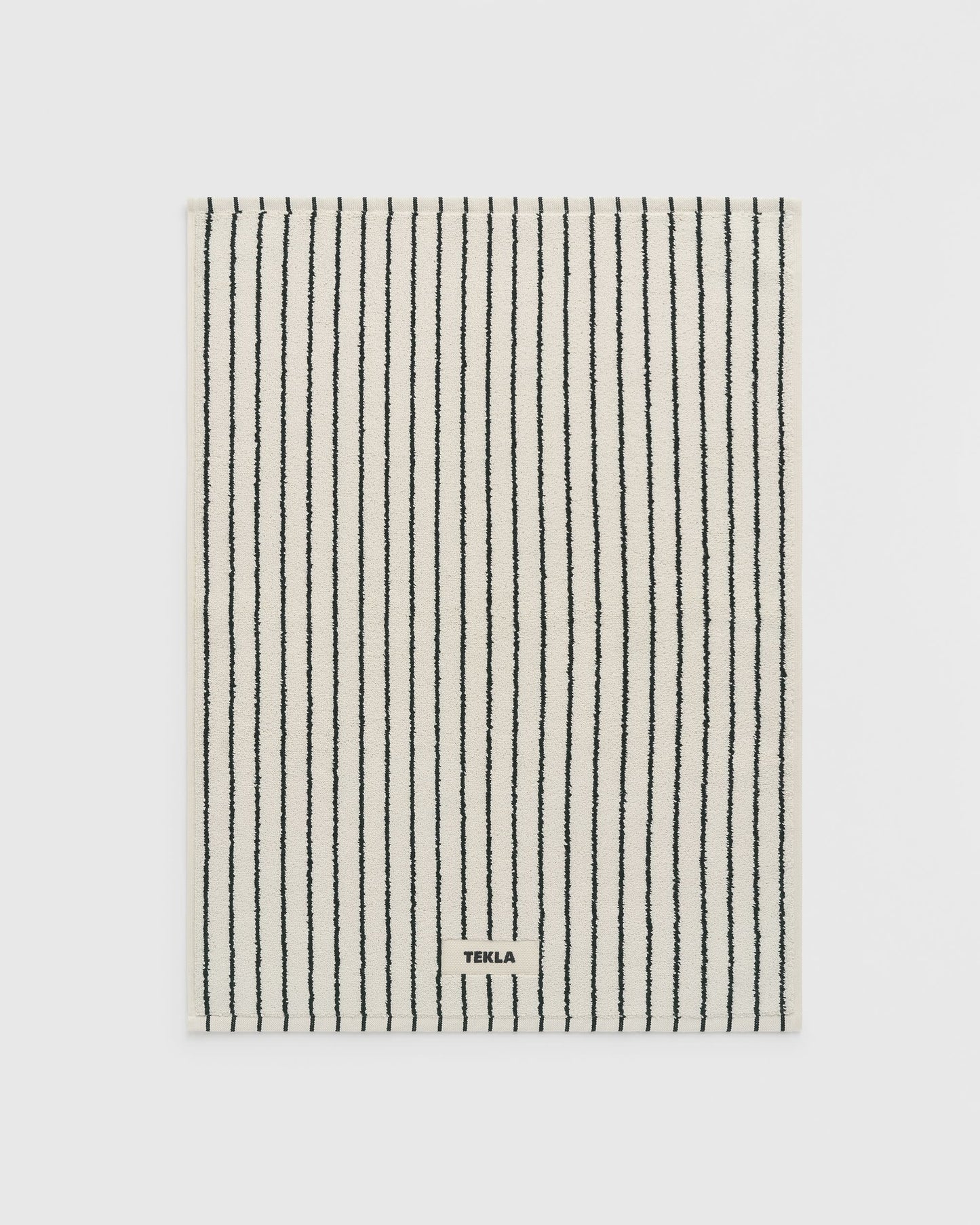 Striped towel with 'Terra' branding on a light gray background