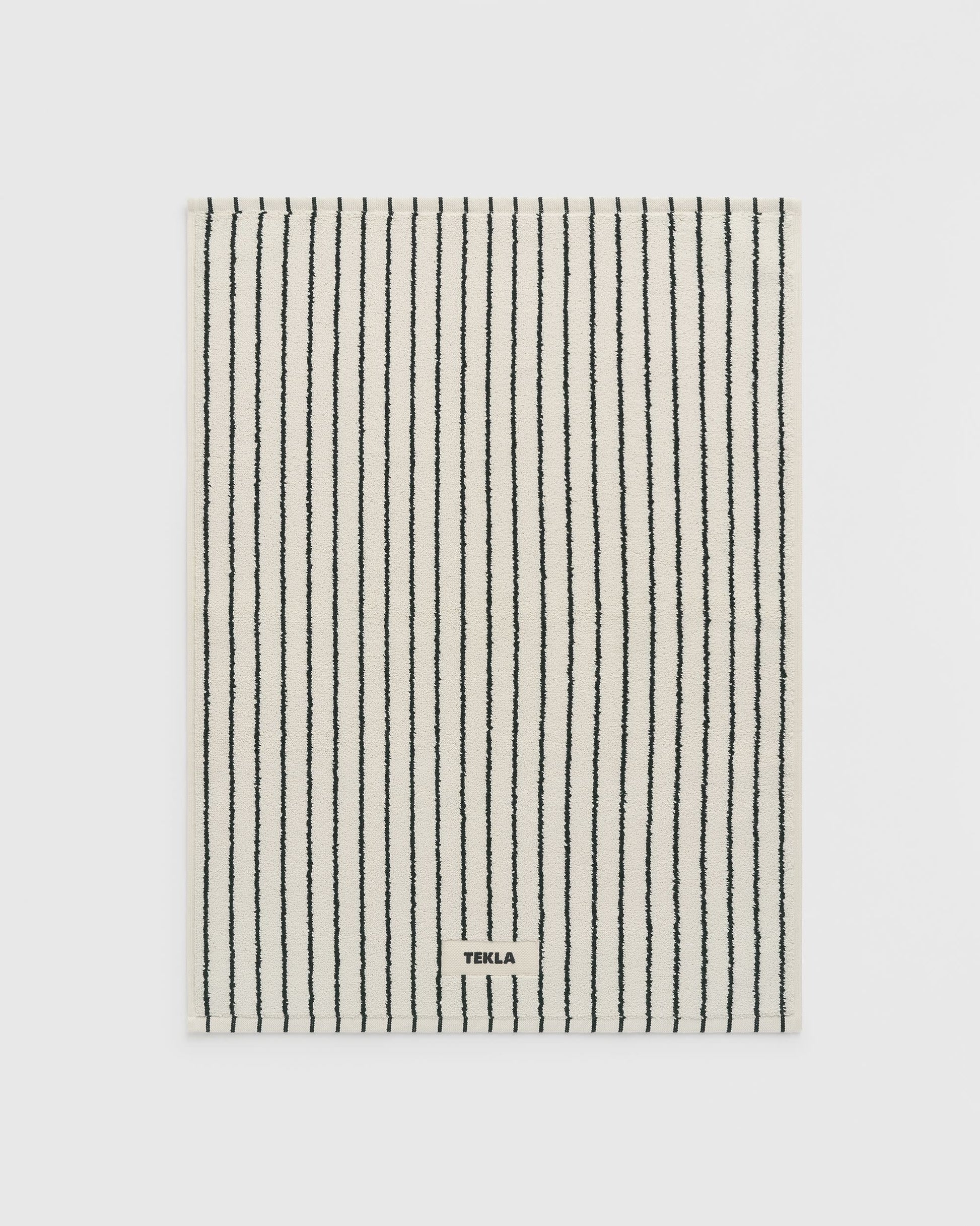 Striped towel with 'Terra' branding on a light gray background