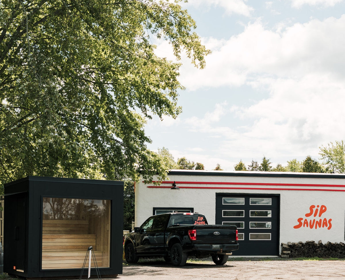 The Sip Saunas shop in Bloomfield, with a black Sip sauna and the truck out front