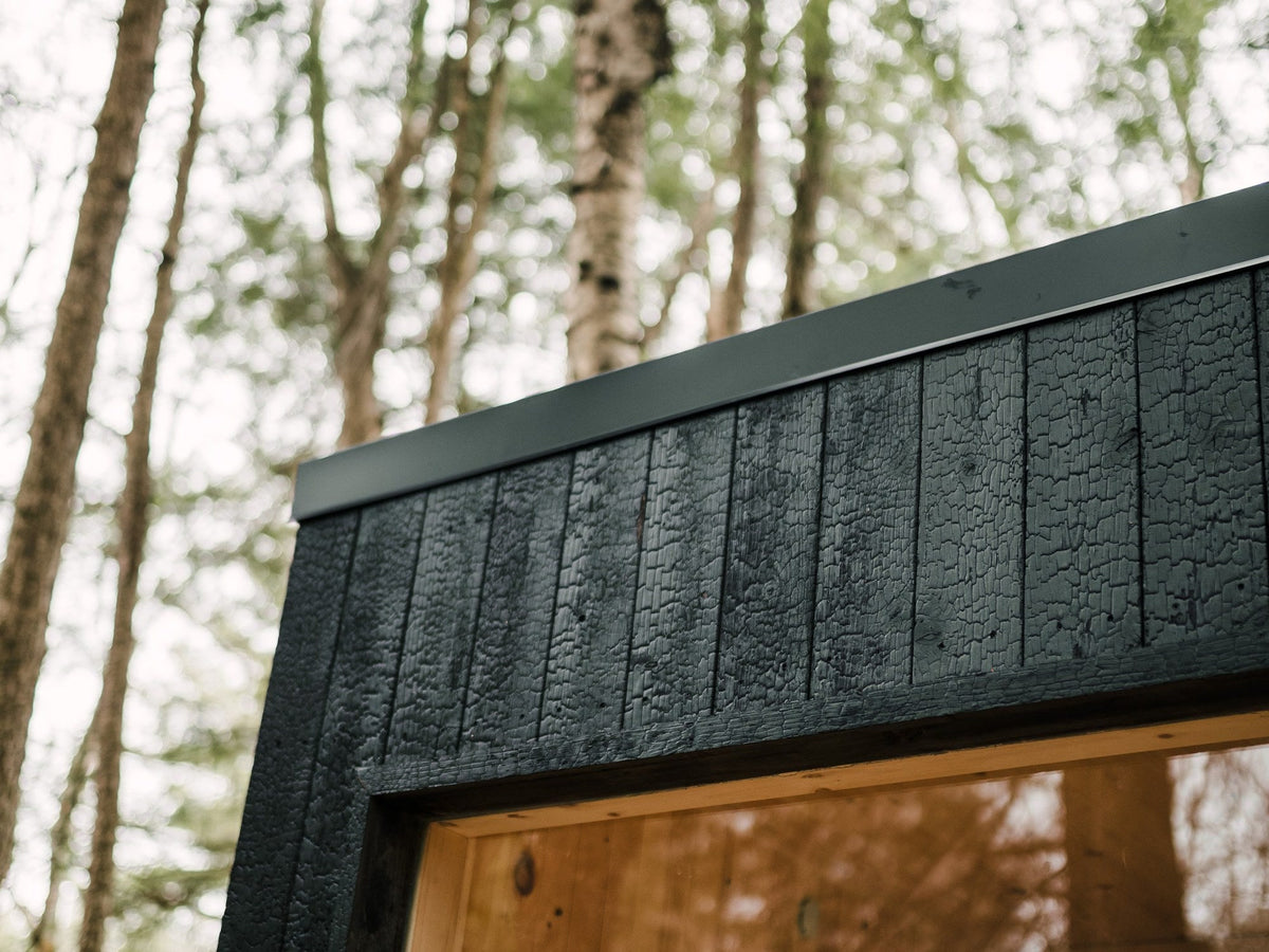 Shou Sugi Ban siding and steel roof flashing on a Sip sauna in the forest